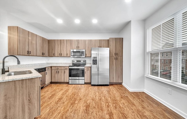 a kitchen with wooden cabinets and stainless steel appliances