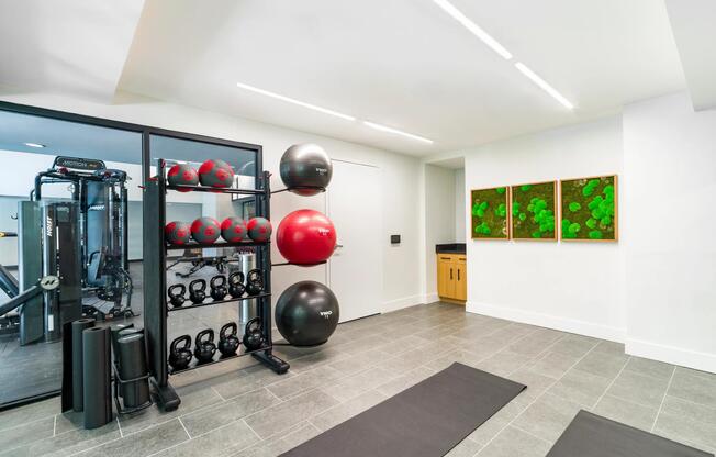 The fitness studio includes dedicated areas for strength training, stretching, and functional workouts, complemented by a variety of free weights and fitness equipment.