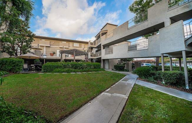 A concrete building with a walkway in front of it.