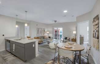 a kitchen and living room with a table and chairs