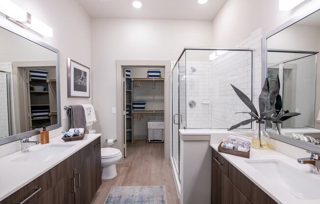 a bathroom with a shower and a sink and a toilet