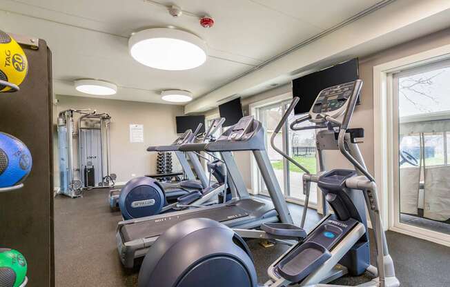 A gym with treadmills and elliptical machines.