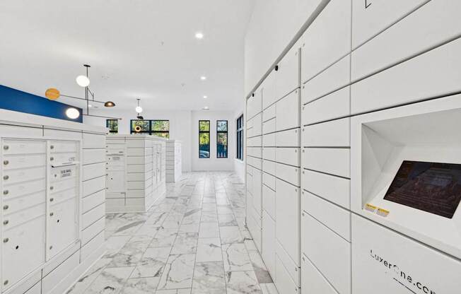 a large white closet with white cabinets and a marble floor at Link Apartments® Calyx, Chapel Hill, 27517