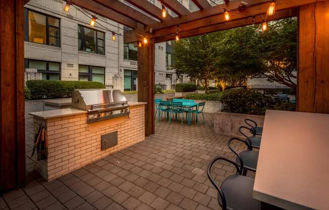 a patio with a grill and tables and chairs at The Parker, Oregon