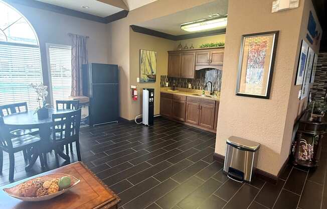 A kitchen with a table and chairs in the foreground.