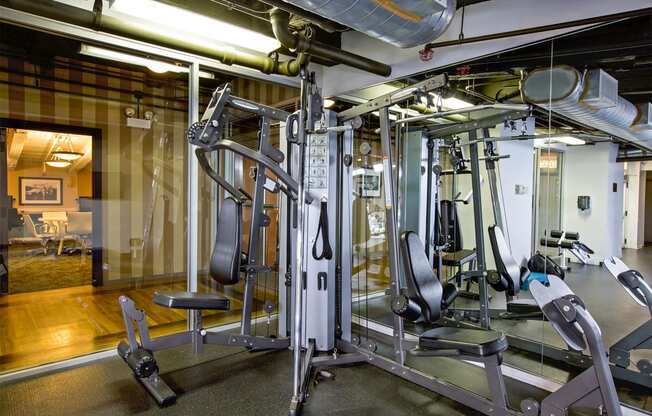 a gym with weights and cardio equipment in a building
