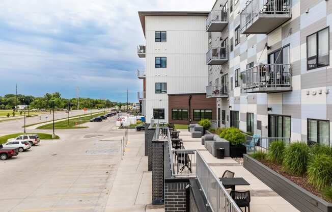 a view of the street from a balcony of a large white building