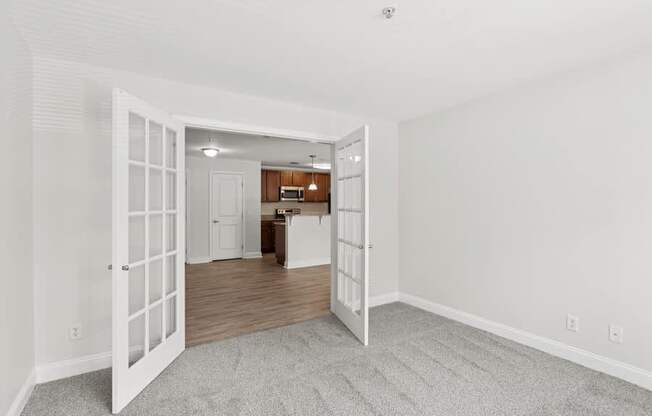 A room with a white door leading to another room.