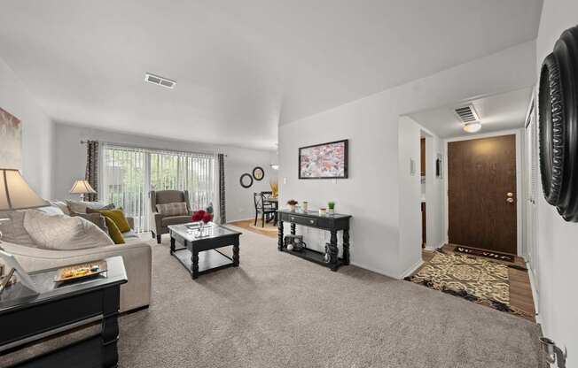 Open and airy living room with natural lighting at Knottingham Apartments in Clinton Township, MI.