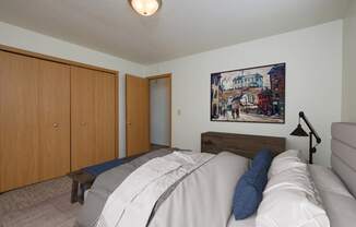 Fargo, ND Twin Parks Apartments. a bedroom with a bed and a chair in a room