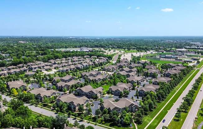 A suburban neighborhood with rows of houses and a clear blue sky.