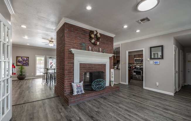 A living room with a fireplace and a ceiling fan.