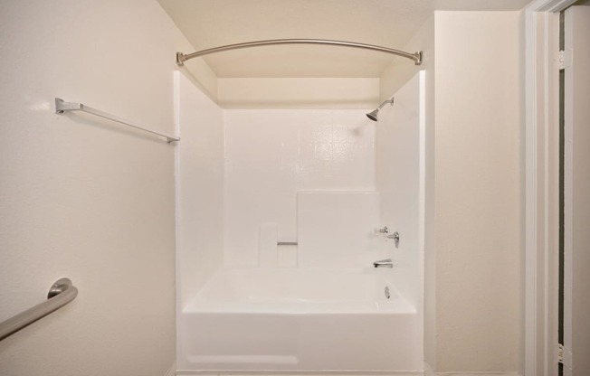 a studio apartment bathroom with a shower and tub