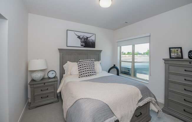 a large bedroom with a bed and a window at The Crossings at Windsong, Prescott Valley, 86314