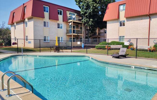 a swimming pool with a building in the background