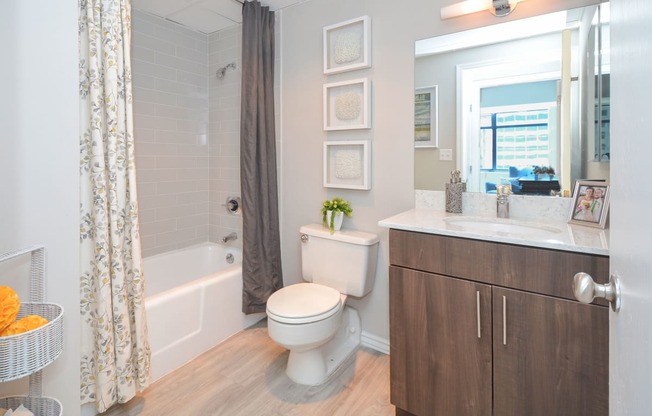 a bathroom with a shower and a toilet and a sink at Apartments at Denver Place, Denver