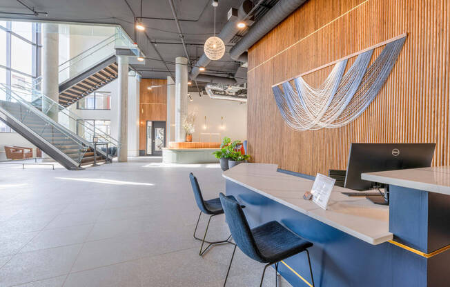 a large open space with a blue desk and blue chairs at Marina Square, WA 98337