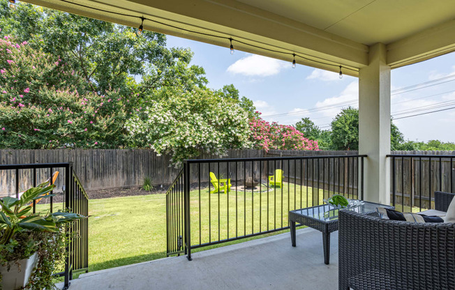 a backyard with a grassy area and a fence