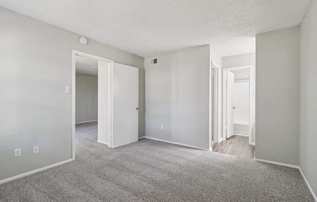 A room with a carpeted floor and white walls.