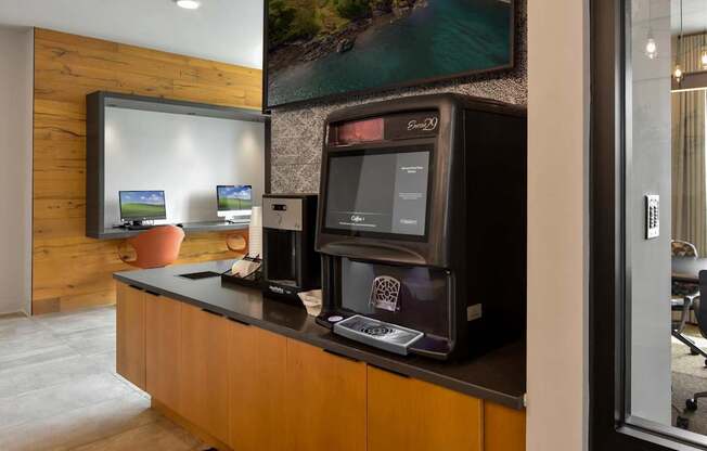 A modern office with a wooden wall and a large screen on the counter.
