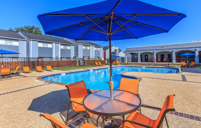 our apartments have a pool and table with umbrellas