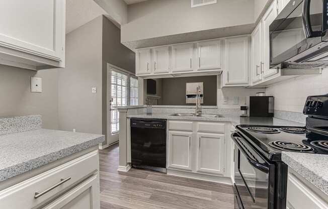 A kitchen with a black stove top oven.