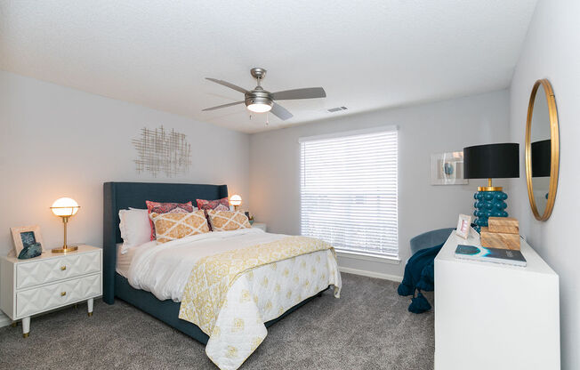 a bedroom with a bed and a ceiling fan