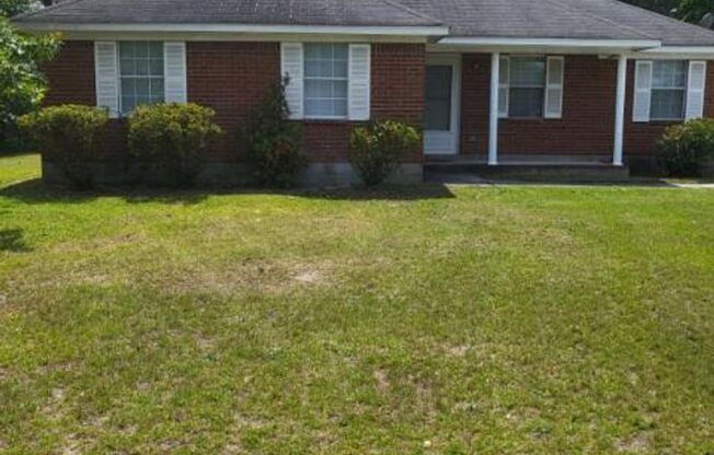 Single family home with covered front porch and back patio.