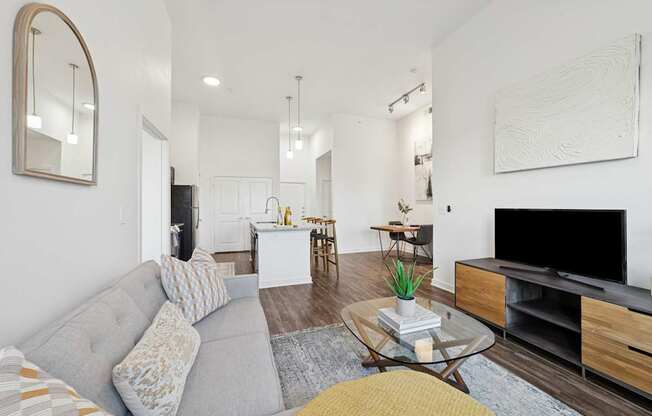 A living room with a grey couch and a coffee table.