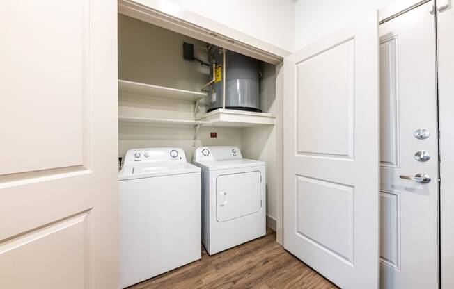 Lenox SoCo Apartments  laundry room with a washer and dryer