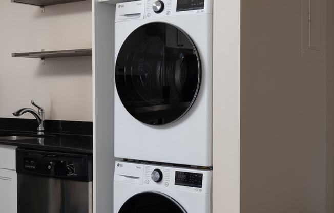 a front loading washer and dryer combo in a kitchen