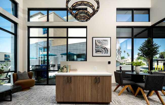 A modern office space with a large window, a wooden desk, and a comfortable chair.