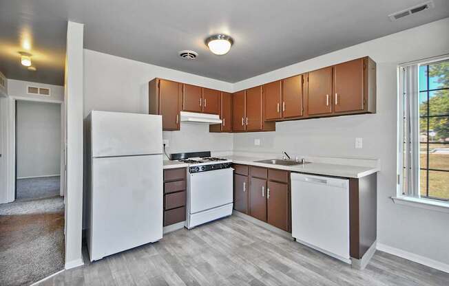 Fully equipped apartment kitchen with modern appliances at Farmbrooke Manor Clinton Township MI