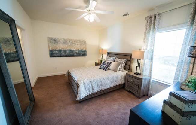 a bedroom with a bed and a ceiling fan