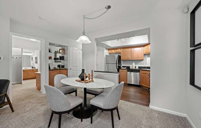 A modern kitchen with a dining table and chairs.