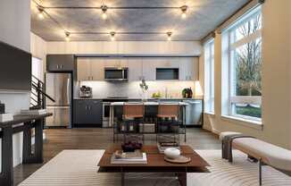 A modern kitchen with a dining table and chairs.