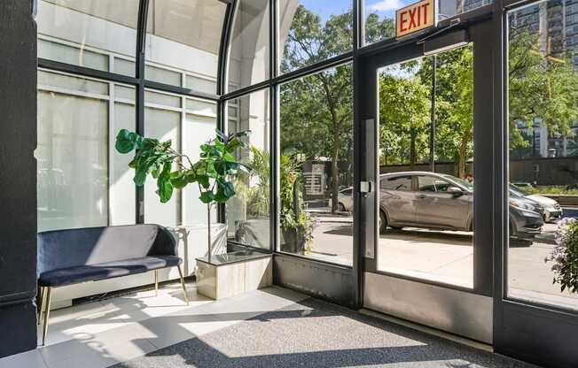 A glass door with an exit sign above it.