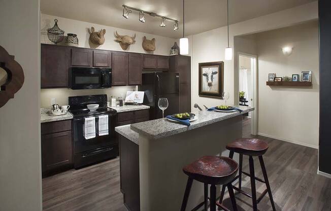 a kitchen with a bar and stools