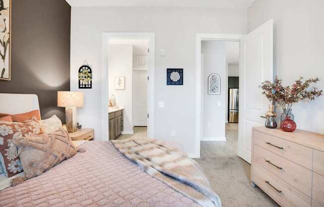 A Bedroom With a Dresser at The Aster Apartments, Cary, NC