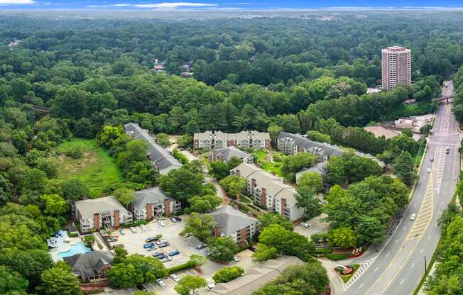 A bird's eye view of a residential area with a road running through it.