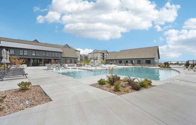 a large swimming pool with a building in the background