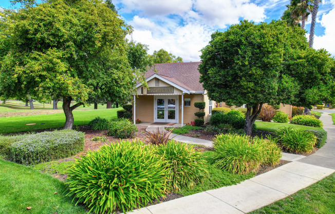 Building Exterior and Leasing Office entrance with green landscaping, Bushes and Trees