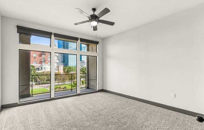 A room with a ceiling fan and a carpeted floor.