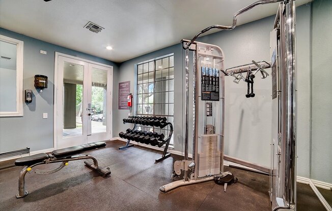 the gym has plenty of equipment and a large window