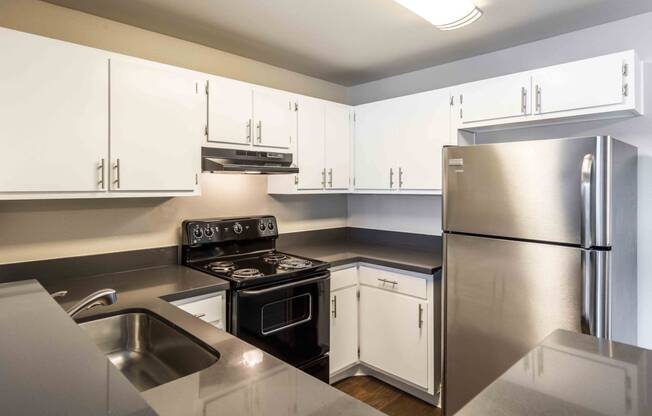 a kitchen with stainless steel appliances and white cabinets