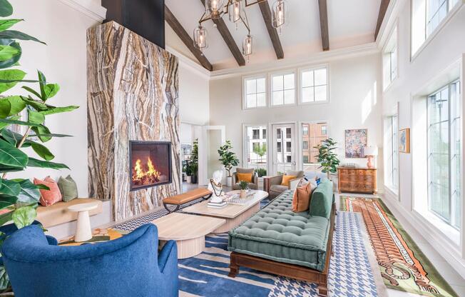 Sophisticated clubroom with abundant natural light, designer finishes, and a warm, inviting fireplace.