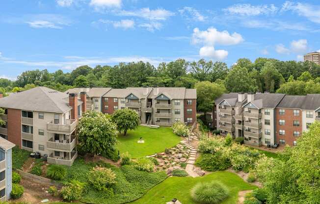 Apartment complex with a green lawn in the middle.