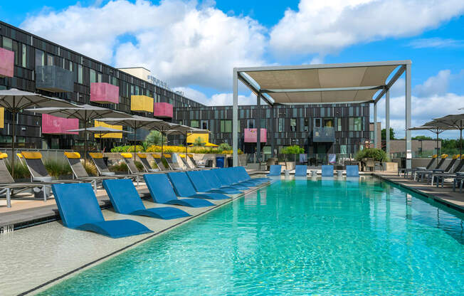 Outdoor Pool Area with Sun Loungers and Shaded Relaxation Zones