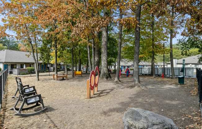 a playground in a park with benches and trees