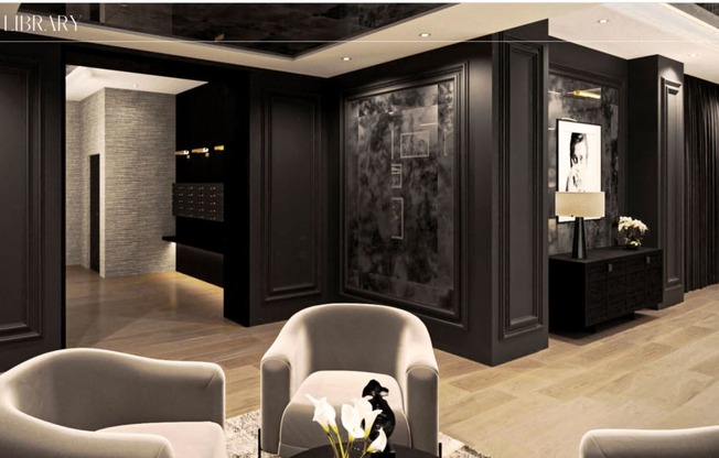 a living room with chairs and a black and white picture at Chateau on Wells, Illinois